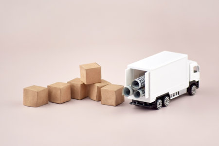 White toy truck with boxes on a light background, space for text.の写真素材
