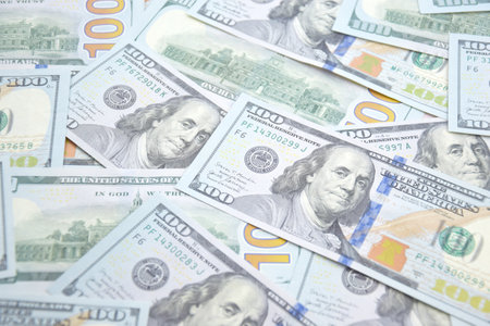 A pile of one hundred US banknotes with president portraits. Cash of hundred dollar bills, dollar...