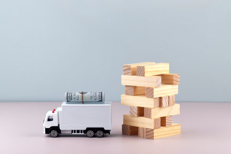 White toy truck with boxes on a light background, space for text.の写真素材
