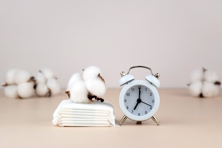 Cotton swabs, white cotton pads on beige background. Body hygiene and personal hygiene concept.