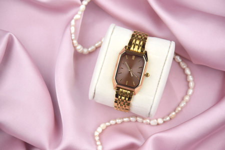 Closeup minimal fashion wristwatch for women on pink background. Fashion and style.の写真素材
