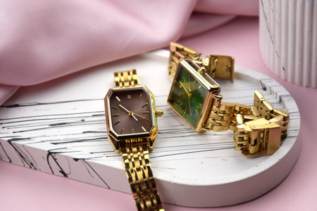 Closeup minimal fashion wristwatch for women on pink background. Fashion and style.の写真素材