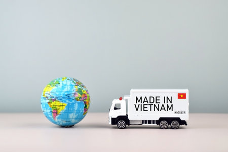 Truck and boxes with the inscription made in Vietnam. Trade tariffs and competition.の写真素材