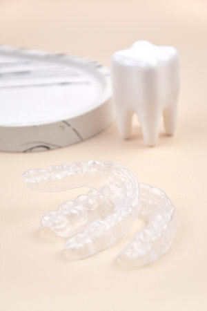Transparent mouth guards for teeth at night after wearing braces.
