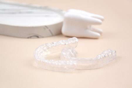 The transparent mouth guards for teeth at night after wearing braces.