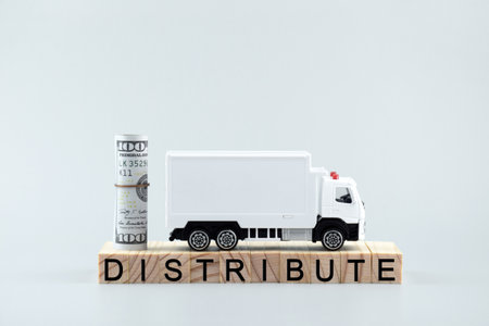 White toy truck on blocks with the text DISTRIBUTE. Logistics and wholesale trade concept.
