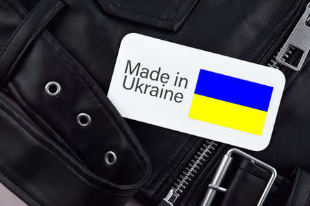 Detail of black leather jacket, label, and the inscription Made in Ukraine. Concept of buying, selling, shopping, and fashionable modern clothingの写真素材