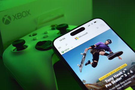 The white Xbox controller with green light.のeditorial素材