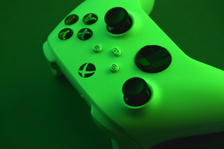 The white Xbox controller with green light.