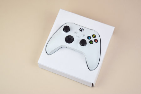 The white Xbox controller on the beige background.