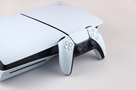 Kharkiv, Ukraine - July 10, 2025: The white Sony PlayStation 5 and controller on the white table.