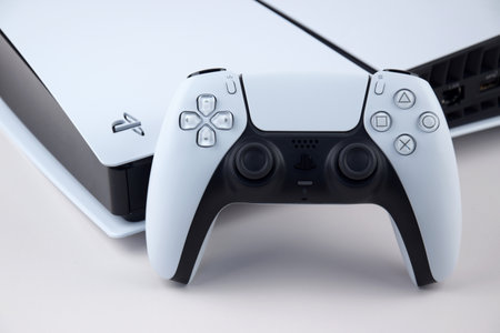 Kharkiv, Ukraine - July 10, 2025: The white Sony PlayStation 5 and controller on the white table.