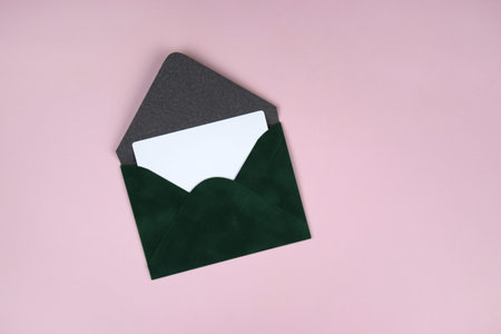 Gift voucher in a green envelope on a light background.の写真素材