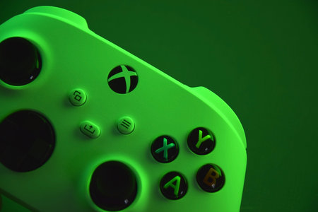 Kharkiv, Ukraine - July 10, 2025: The white Xbox controller with green light.のeditorial素材