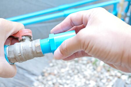 Valve and joint installation by hand. PVC pipe installation. DIY water system at home.