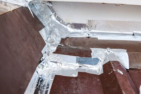 Roof repairing by using aluminum foil tape to prevent water leak before rainy season