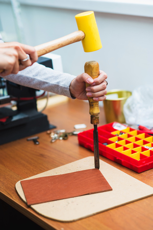 caucasian leather craft working as artisan in her workshopの写真素材