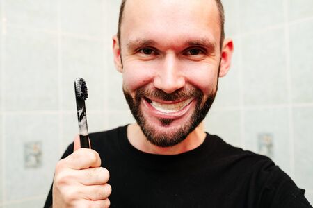 Portrait of handsome man getting hurt while shaving with a razor