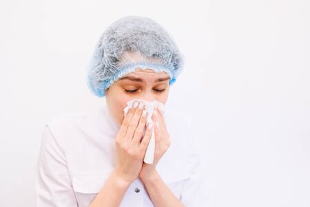 doctor woman Cough in tissue covering nose and mouth when coughing as COVID-19の写真素材