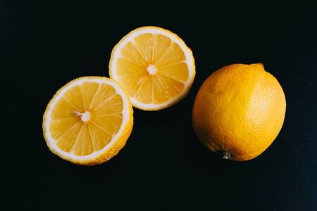 fresh lemon on black background. two lemons.