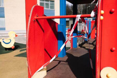 An empty playground for children in the yard. Fenced territory, coronavirus