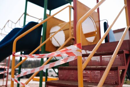 An empty playground for children in the yard. Fenced territory, coronavirusの写真素材