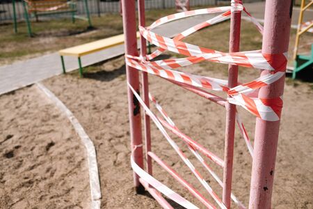 An empty playground for children in the yard. Fenced territory, coronavirus