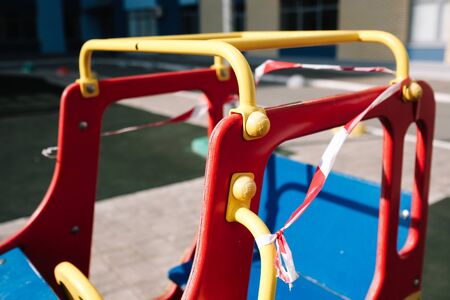 An empty playground for children in the yard. Fenced territory, coronavirusの写真素材