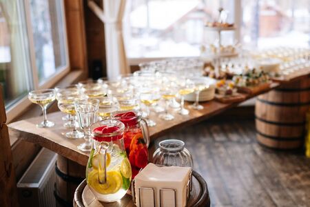 Glasses with seafood snacks and meat on banquet table, close upの写真素材