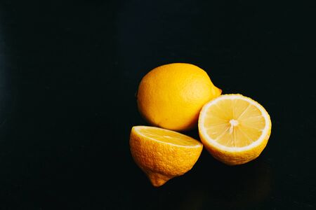 fresh lemon on black background. two lemons.の写真素材
