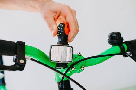 Installation of a front reflective green fix bike with white tires. Close-upの写真素材