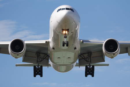 Head on landing commercial jet airplane on the sky
