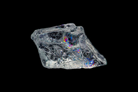 Closeup natural rough rainbow aquamarine (beryl group) gemstone on dark background (selective focus)の写真素材