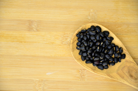 cereals, black beans on wood boardの写真素材