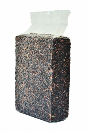 Unpolished rice in vacuum packaging isolate on white background.の写真素材