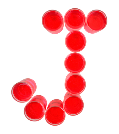 One letter of the alphabet. red drink in a glassの写真素材