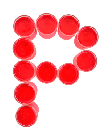 One letter of the alphabet. red drink in a glassの写真素材