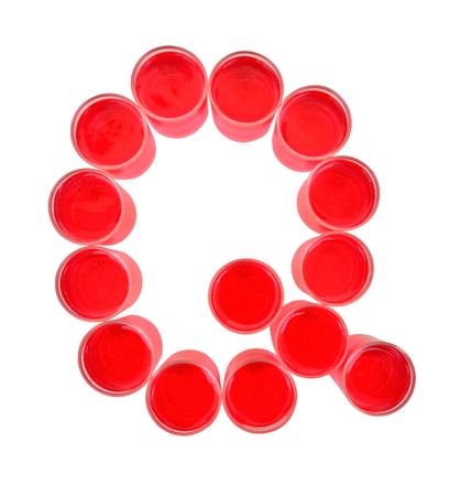 One letter of the alphabet. red drink in a glassの写真素材