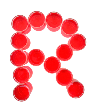 One letter of the alphabet. red drink in a glassの写真素材