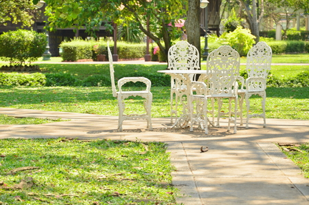 White garden furniture on green grassの写真素材