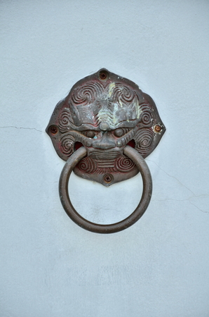 old style lion's head knocker isolated on white backgroundの写真素材