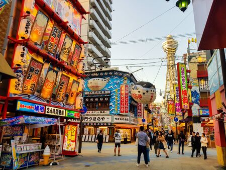 OSAKA , JAPAN - MAR 26 2018 : The Shinsekai market is the famous night street with restaurant and retail stores and landmark Tsutenkaku Tower in Osaka.のeditorial素材