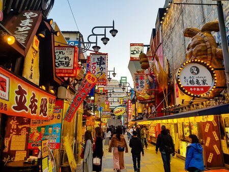 OSAKA, JAPAN - MAR 26 2018 : The Shinsekai market is the famous night street with restaurant and retail stores and landmark Tsutenkaku Tower in Osaka.のeditorial素材