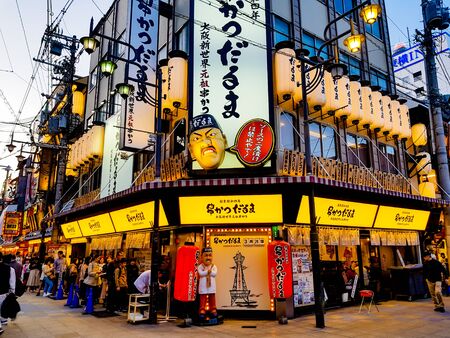 OSAKA, JAPAN - MAR 26 2018 : The Shinsekai market is the famous night street with restaurant and retail stores and landmark Tsutenkaku Tower in Osaka.のeditorial素材