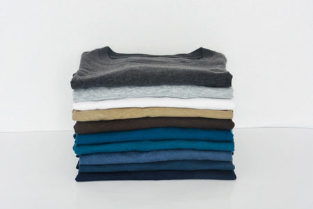stack of t-shirt on white background, copy spaceの写真素材