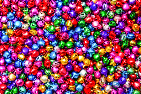 stack of mixed small colorful bells textured background (selective focus)の写真素材