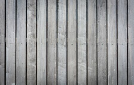 background texture of old wood fence, raw wood fence. vertical planksの写真素材