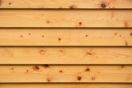 layer of horizontal natural pine wood planks strips wall background texture wide with natural eyelets and grungeの写真素材