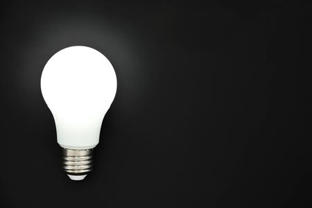 LED light bulb on black background, concept of ideas, creativity, innovation or saving energy, copy...