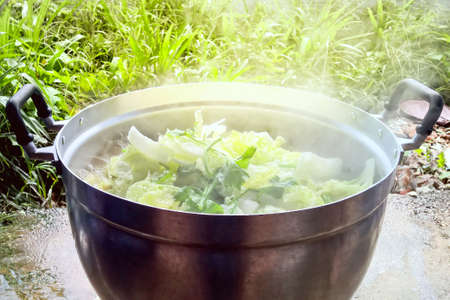 Thai food Tom Jab Chai mixed vegetables stew is boiling in potの写真素材